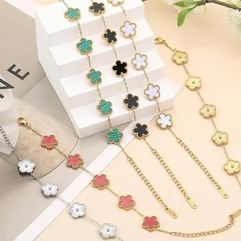 Double Sided Clover Charm Bracelet featuring gold and silver tones with multiple clover designs.