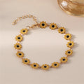 Minimalist Daisy Flower Charm Bracelet showcasing a delicate daisy design with gold accents and black centers.