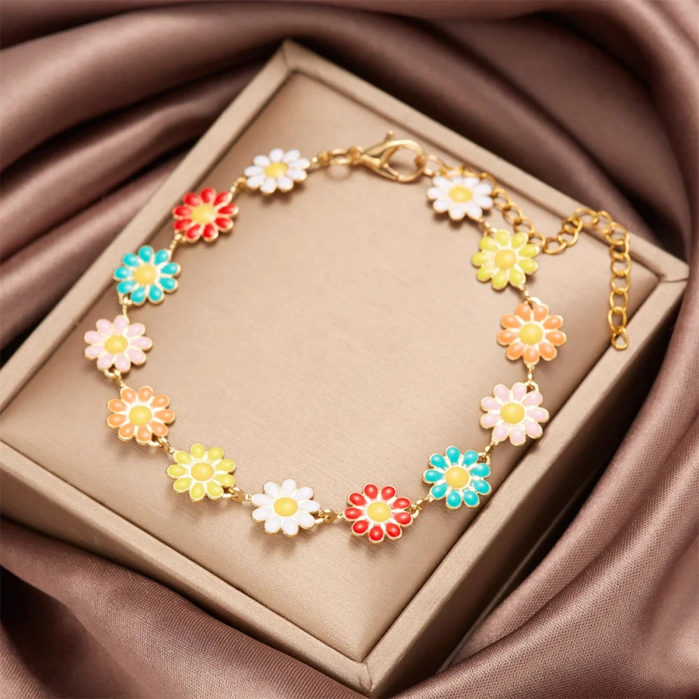 Minimalist Daisy Flower Charm Bracelet featuring colorful daisy charms on a gold chain in an elegant display.
