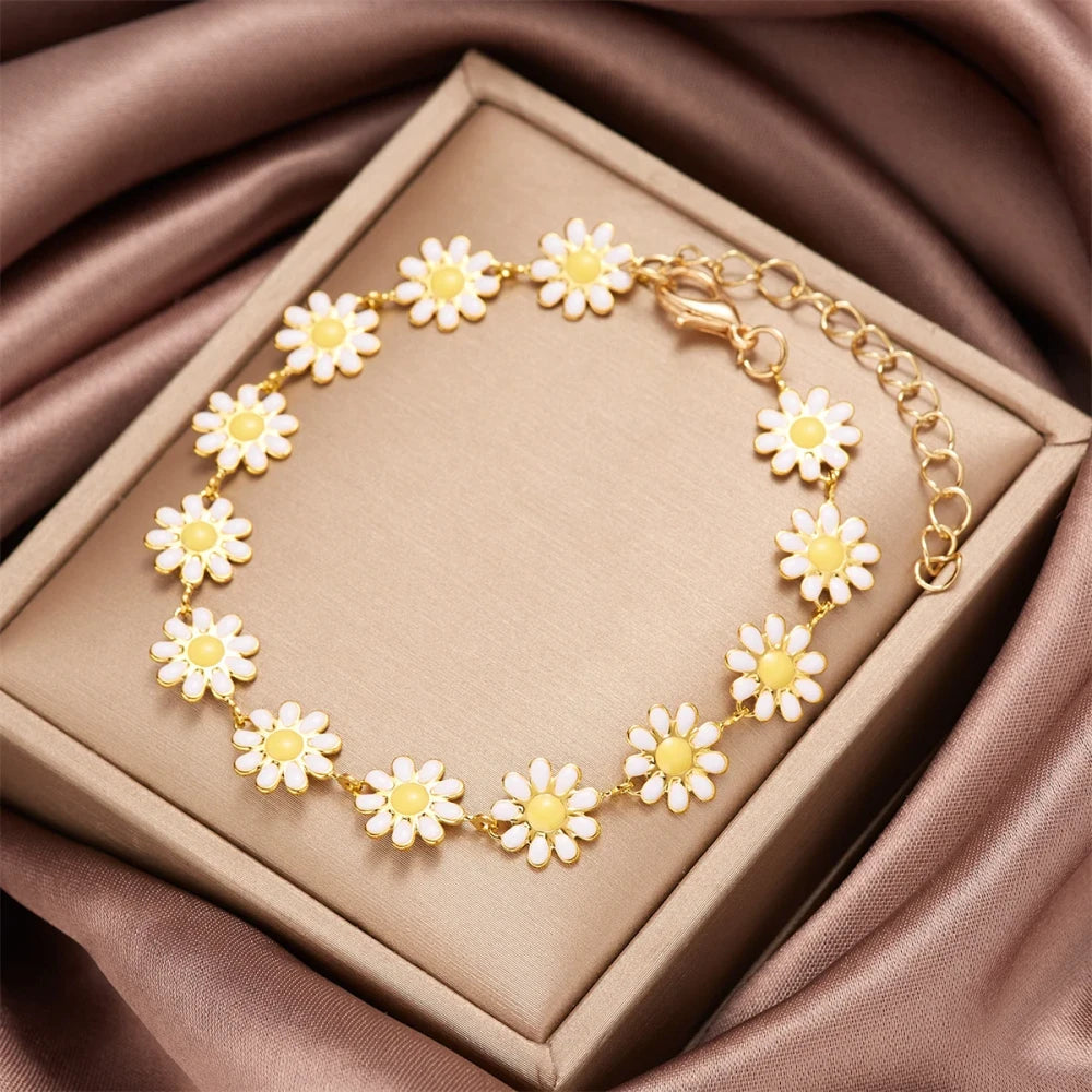 Minimalist Daisy Flower Charm Bracelet displayed in a jewelry box with a soft fabric background.
