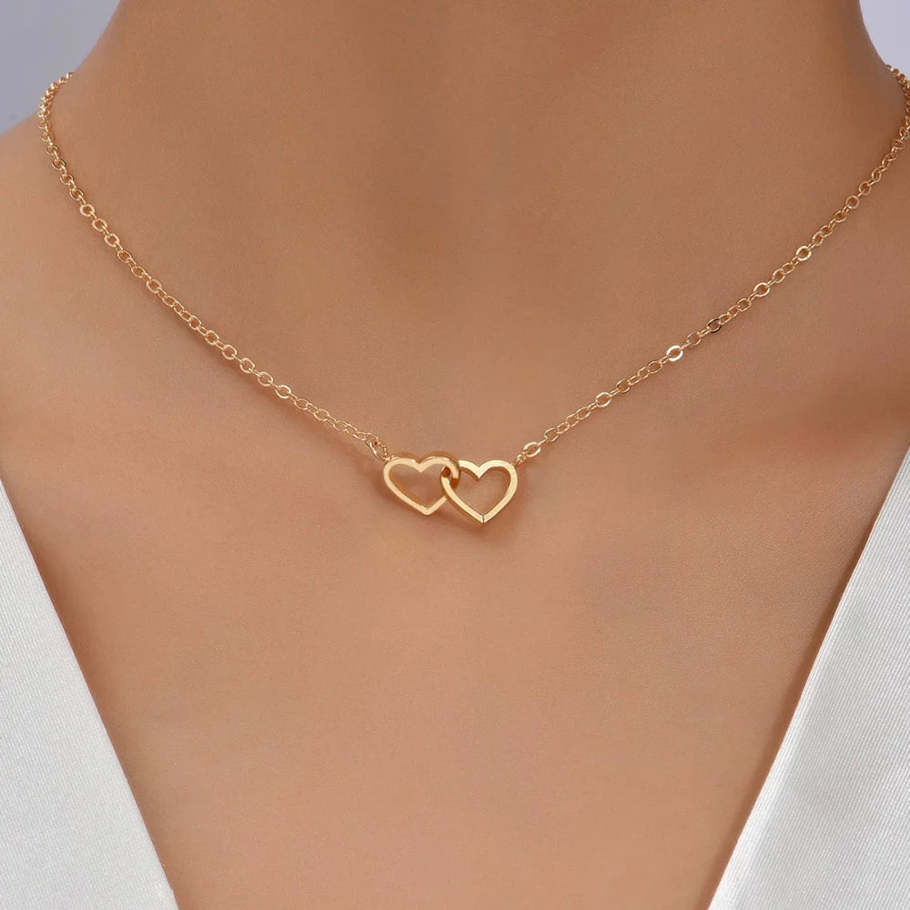 Double Hollow Heart Chain Necklace worn elegantly, featuring a double heart design in gold.