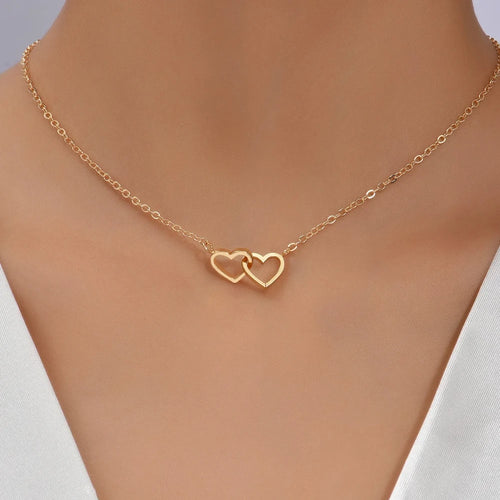 Double Hollow Heart Chain Necklace worn elegantly, featuring a double heart design in gold.