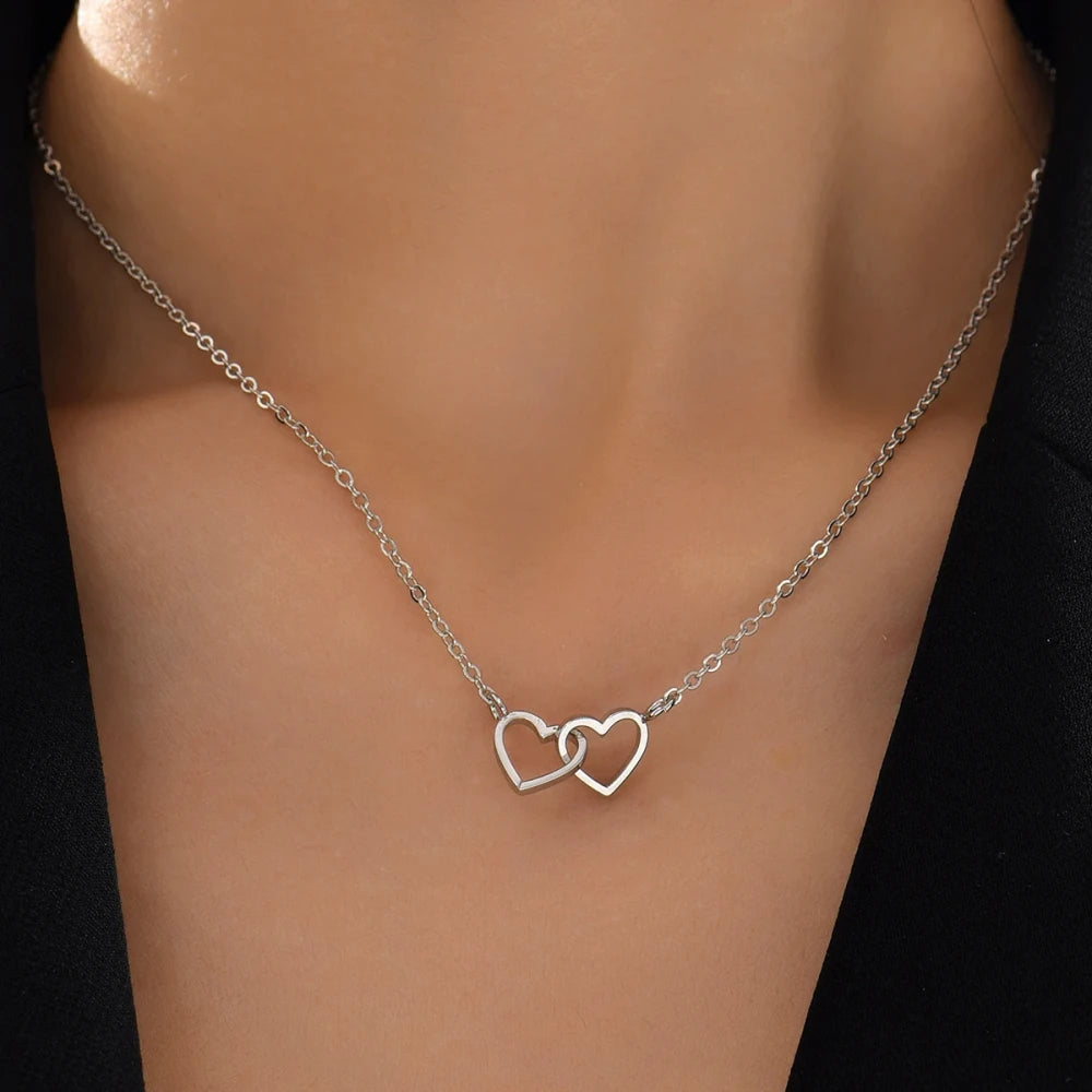 Double Hollow Heart Chain Necklace featuring two intertwined hollow hearts on a delicate chain.